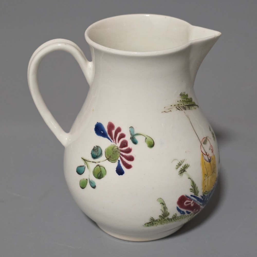 An 18th-century Worcester porcelain sparrow beak cream jug of baluster form, hand-painted with polychrome enamel figures and foliage. View V