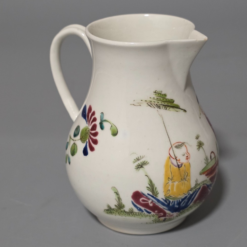 An 18th-century Worcester porcelain sparrow beak cream jug of baluster form, hand-painted with polychrome enamel figures and foliage. View VI