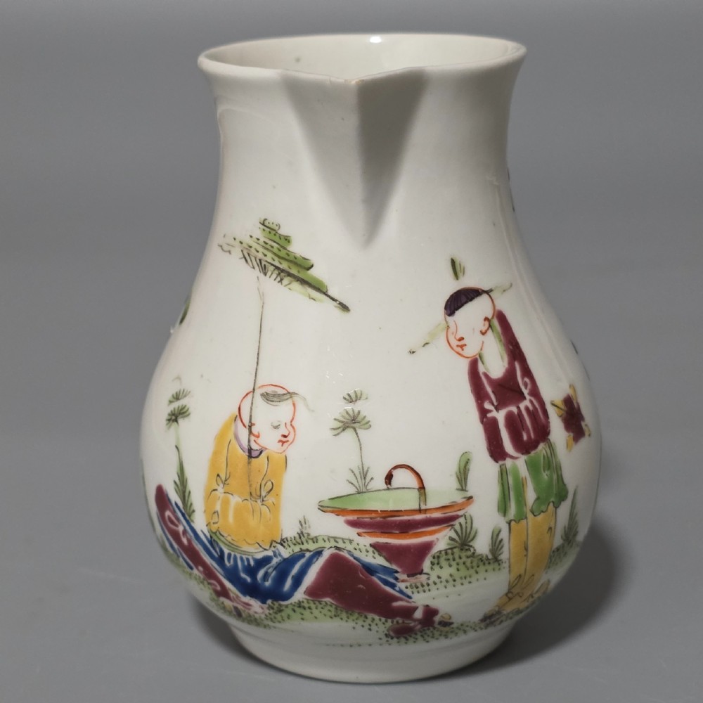 An 18th-century Worcester porcelain sparrow beak cream jug of baluster form, hand-painted with polychrome enamel figures and foliage. View VII
