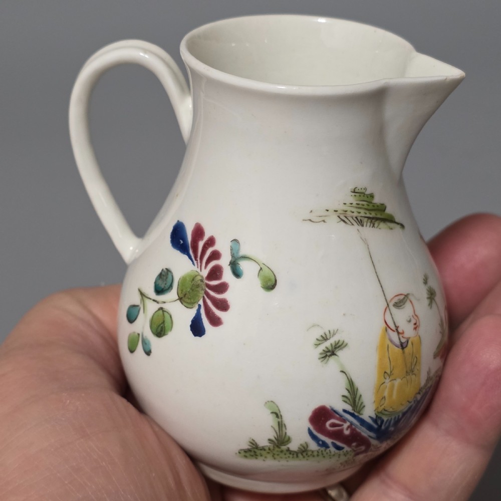 An 18th-century Worcester porcelain sparrow beak cream jug of baluster form, hand-painted with polychrome enamel figures and foliage. View XI