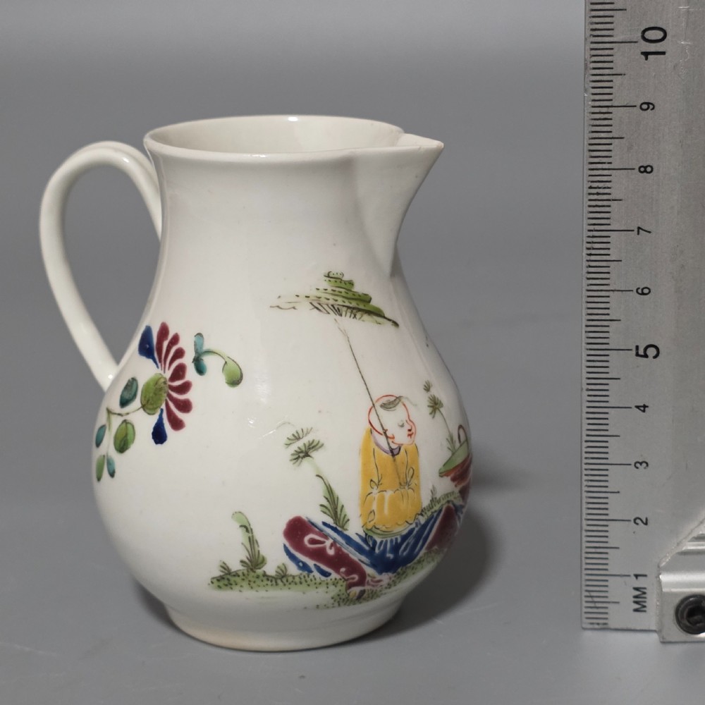 An 18th-century Worcester porcelain sparrow beak cream jug of baluster form, hand-painted with polychrome enamel figures and foliage. View XII