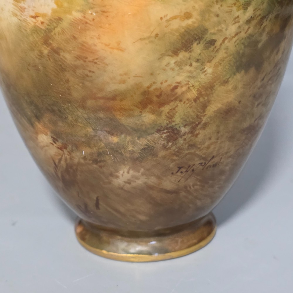 A tall porcelain vase featuring twin gilded handles and a handpainted landscape scene depicting Windsor Castle against a soft sunset sky. View VIII