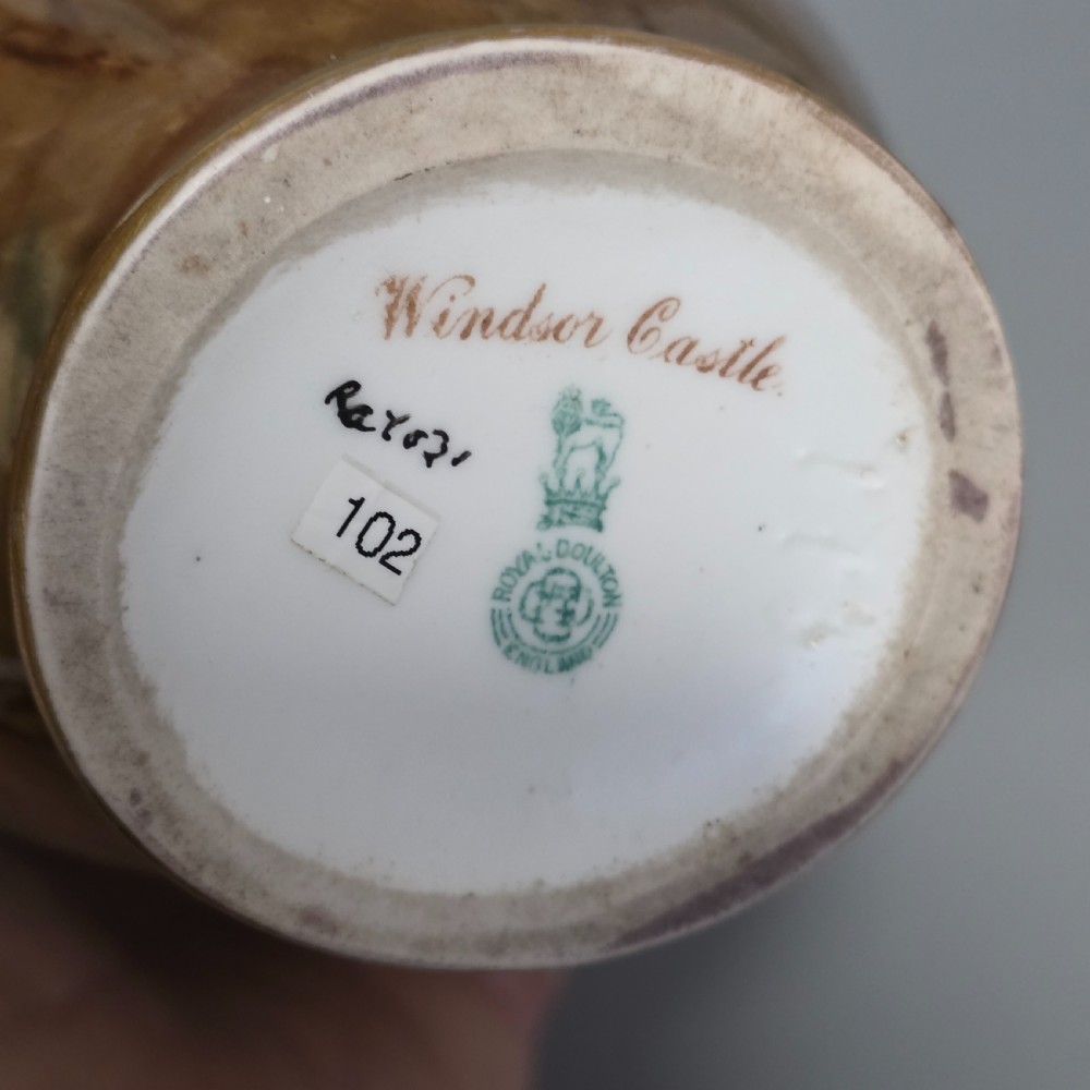 A tall porcelain vase featuring twin gilded handles and a handpainted landscape scene depicting Windsor Castle against a soft sunset sky. View XIII