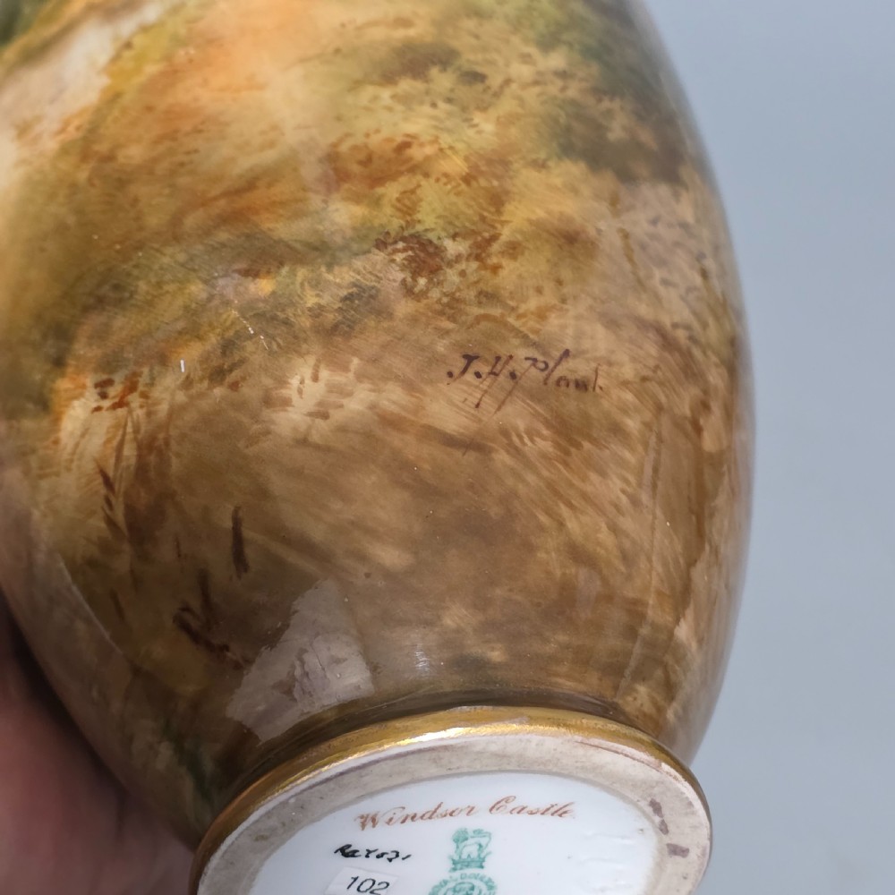 A tall porcelain vase featuring twin gilded handles and a handpainted landscape scene depicting Windsor Castle against a soft sunset sky. View XVI