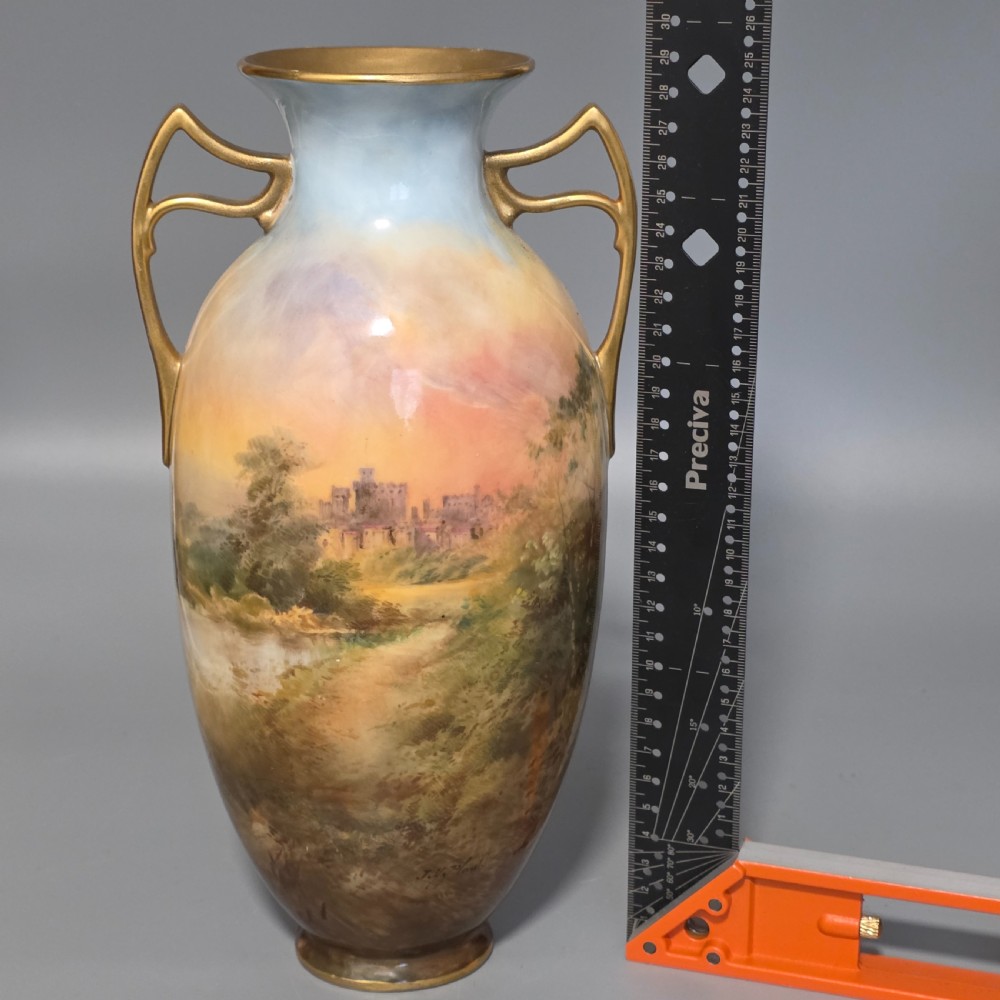 A tall porcelain vase featuring twin gilded handles and a handpainted landscape scene depicting Windsor Castle against a soft sunset sky. View XVIII