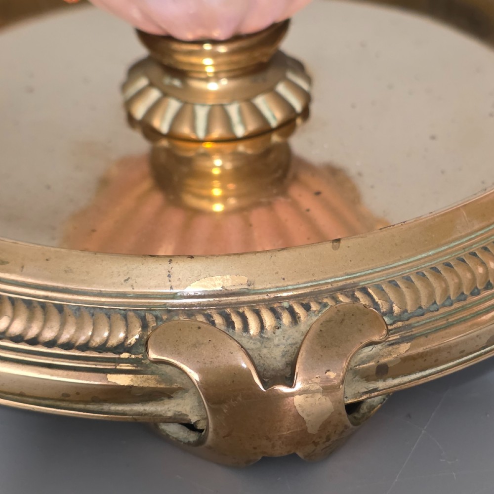 A fluted pastel green and pink porcelain inkwell decorated with applied floral swags, mounted on a turned brass pedestal within a circular brass tray base. View VII