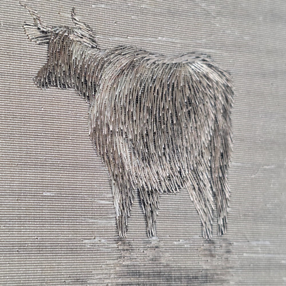 A framed Chinese silk embroidery panel depicting cattle standing in water in front of a mountainous background, presented in a wide oak frame. View VIII