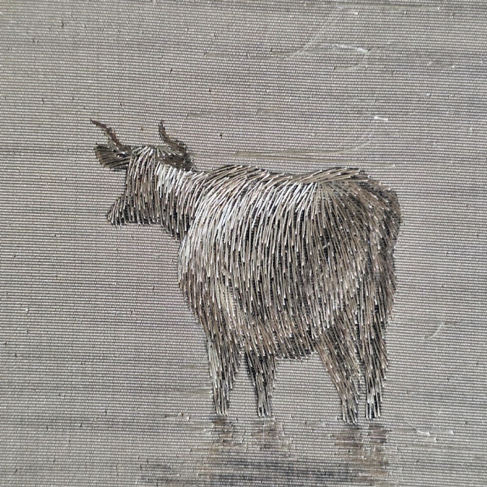 A framed Chinese silk embroidery panel depicting cattle standing in water in front of a mountainous background, presented in a wide oak frame. View X