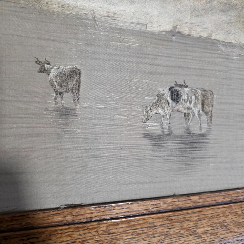 A framed Chinese silk embroidery panel depicting cattle standing in water in front of a mountainous background, presented in a wide oak frame. View XIII