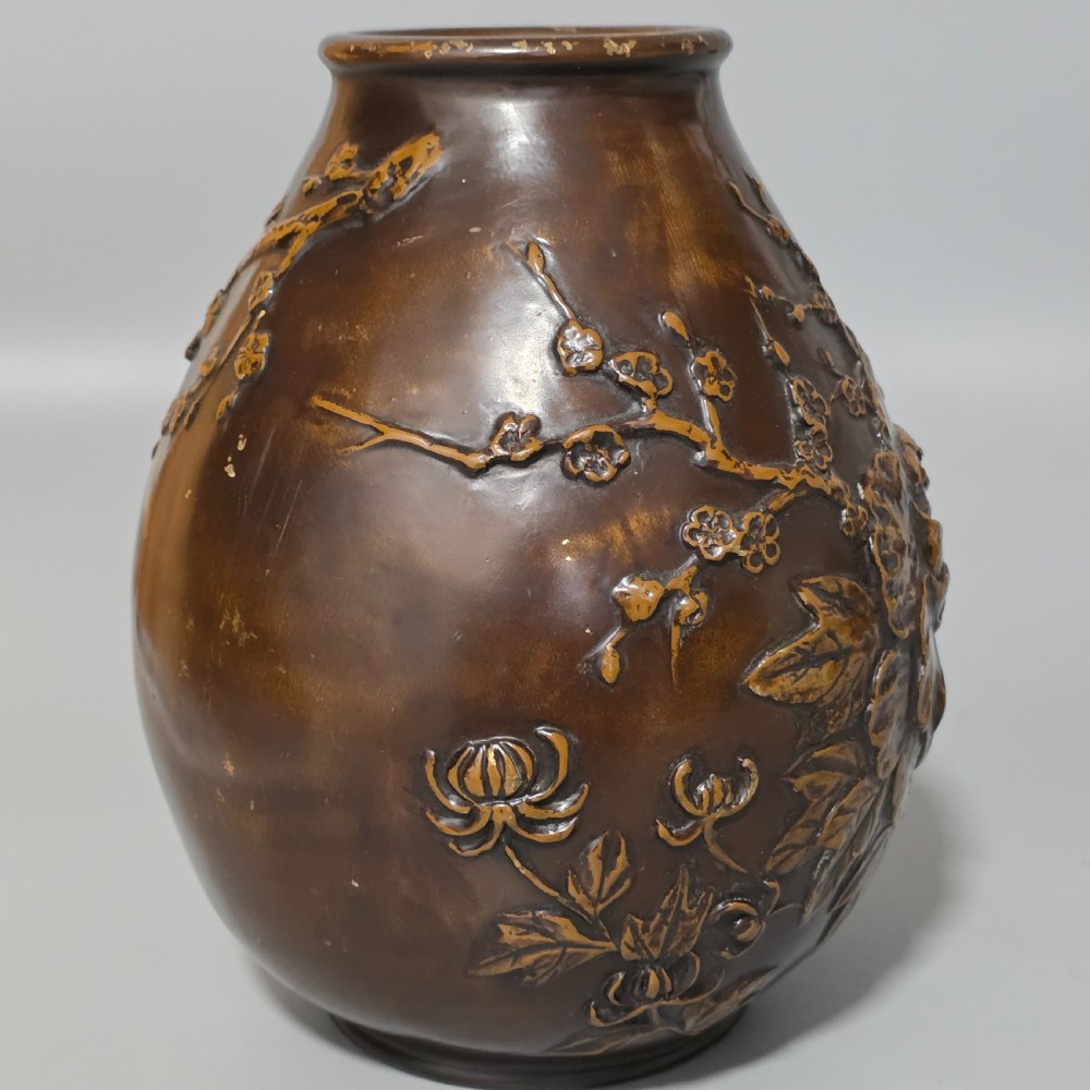 A dark brown patinated bronze vase featuring raised high-relief floral carvings of large peonies and chrysanthemums. View III