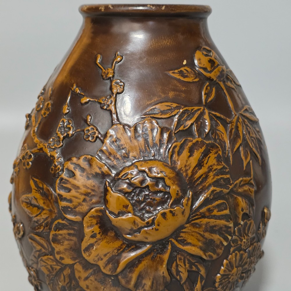 A dark brown patinated bronze vase featuring raised high-relief floral carvings of large peonies and chrysanthemums. View IV
