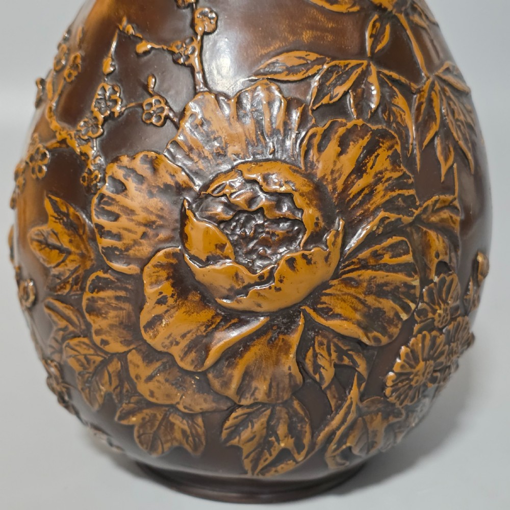 A dark brown patinated bronze vase featuring raised high-relief floral carvings of large peonies and chrysanthemums. View XII