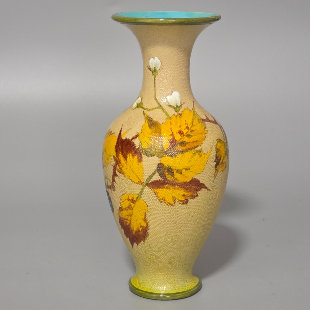 A baluster-shaped Doulton Lambeth ceramic vase featuring a textured lace-patterned buff background painted with botanical autumn leaves and blackberries, finished with a bright turquoise interior rim. View II