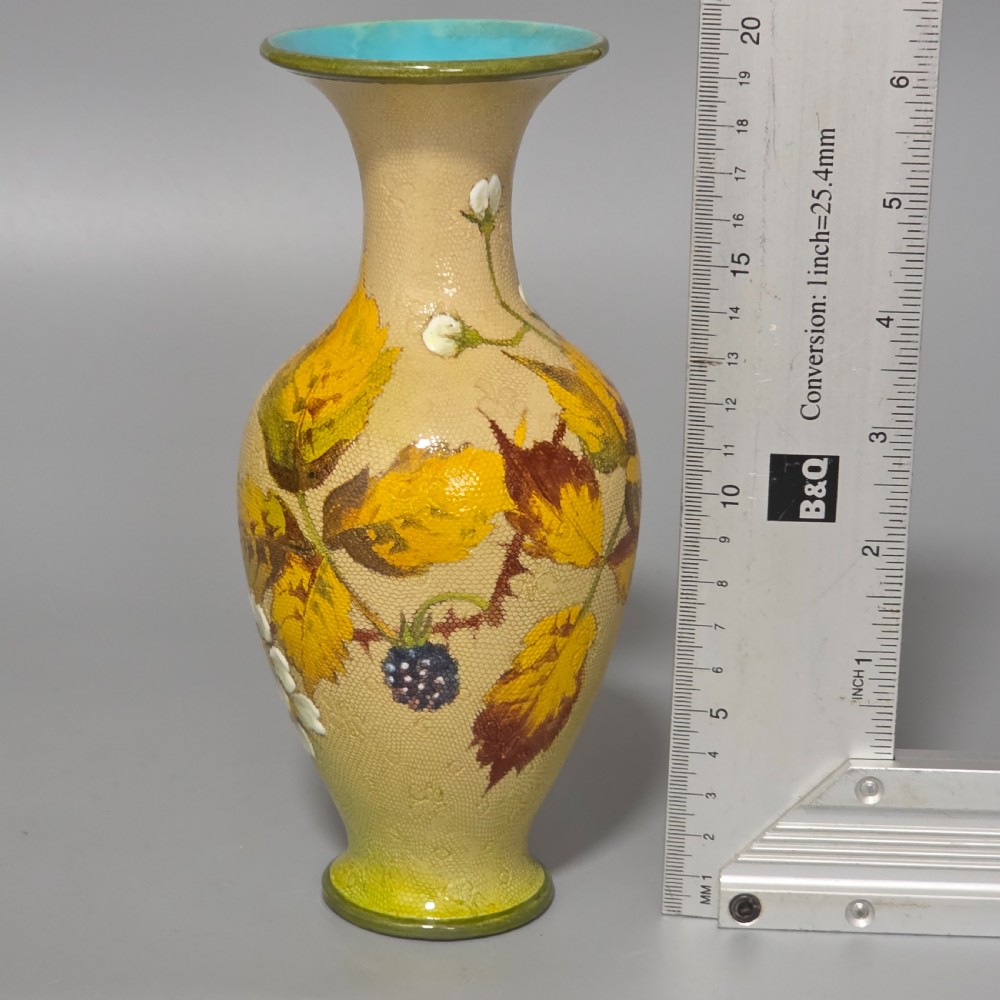 A baluster-shaped Doulton Lambeth ceramic vase featuring a textured lace-patterned buff background painted with botanical autumn leaves and blackberries, finished with a bright turquoise interior rim. View XI