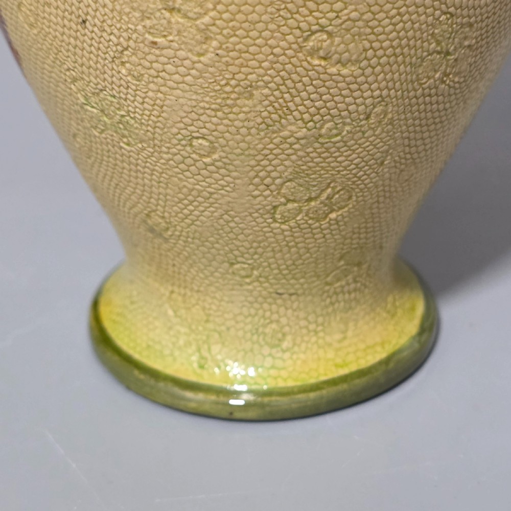 A baluster-shaped Doulton Lambeth ceramic vase featuring a textured lace-patterned buff background painted with botanical autumn leaves and blackberries, finished with a bright turquoise interior rim. View XIII