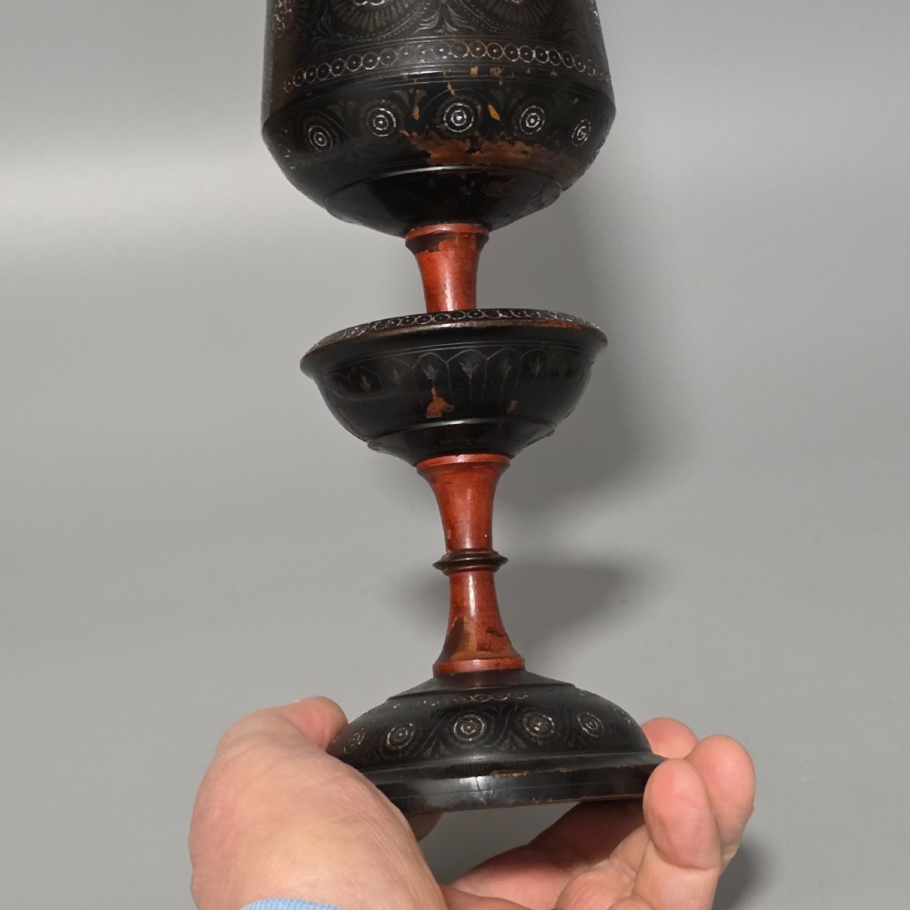 A tall 19th-century lacquered tapering vase with intricate incised geometric motifs on a turned pedestal stem. View V