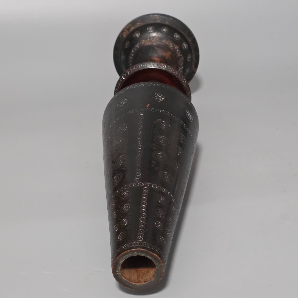 A tall 19th-century lacquered tapering vase with intricate incised geometric motifs on a turned pedestal stem. View XIX