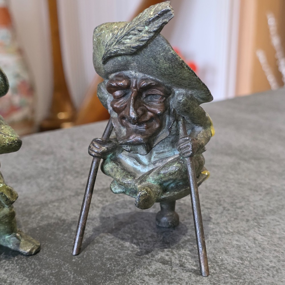 A pair of early twentieth-century French patinated bronze candle holders cast in the form of grotesque satirical caricature figures. View II