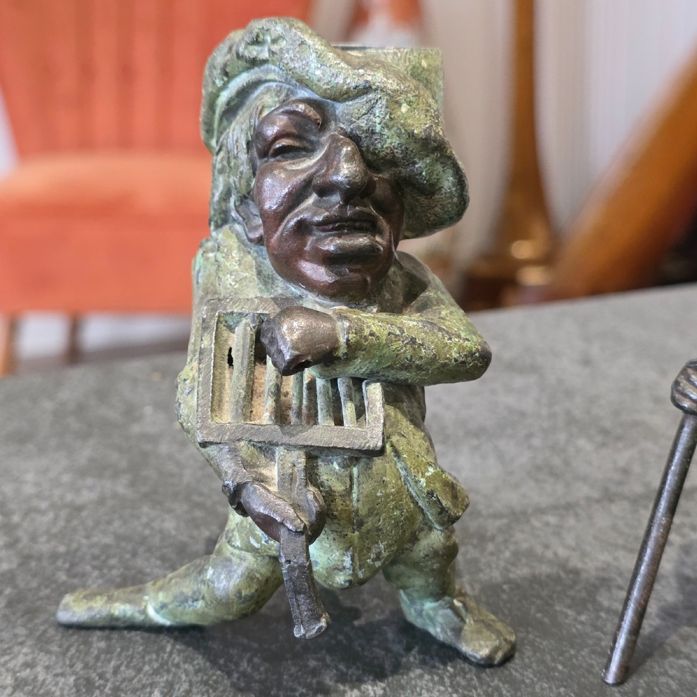 A pair of early twentieth-century French patinated bronze candle holders cast in the form of grotesque satirical caricature figures. View III