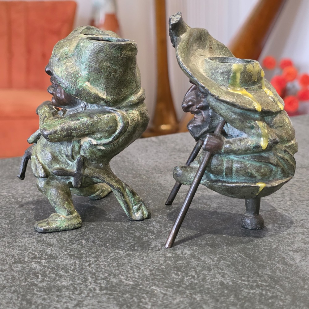 A pair of early twentieth-century French patinated bronze candle holders cast in the form of grotesque satirical caricature figures. View VI