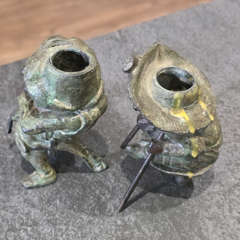 A pair of early twentieth-century French patinated bronze candle holders cast in the form of grotesque satirical caricature figures. View VII