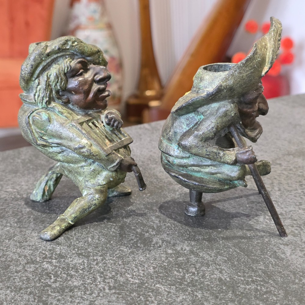 A pair of early twentieth-century French patinated bronze candle holders cast in the form of grotesque satirical caricature figures. View VIII