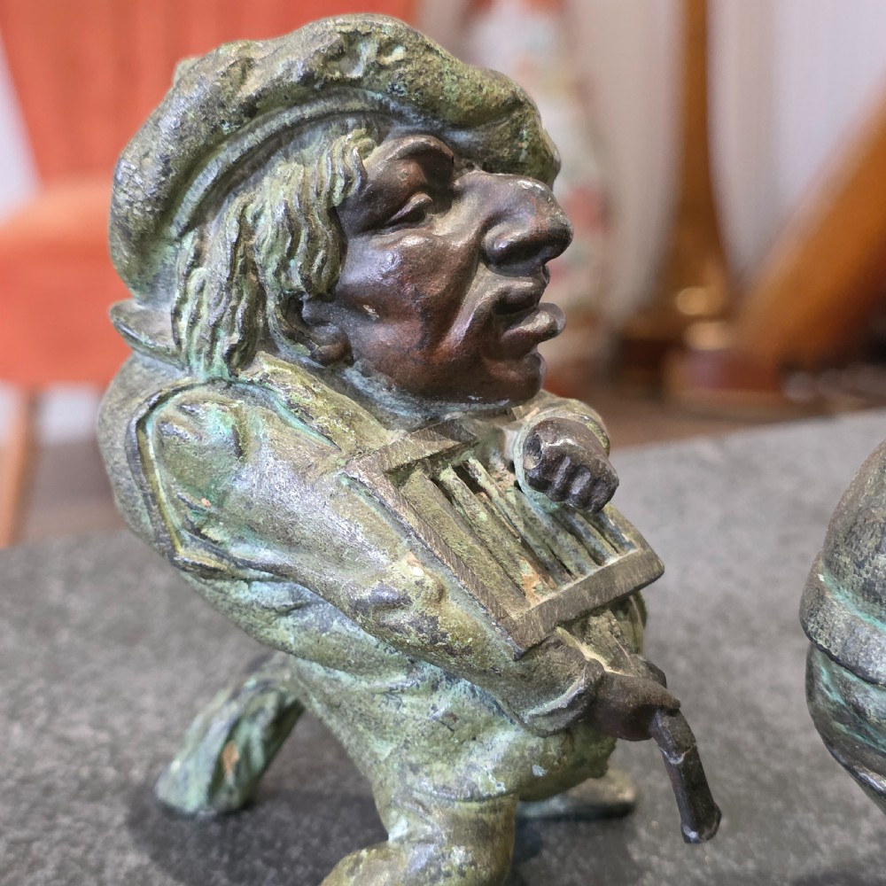 A pair of early twentieth-century French patinated bronze candle holders cast in the form of grotesque satirical caricature figures. View IX