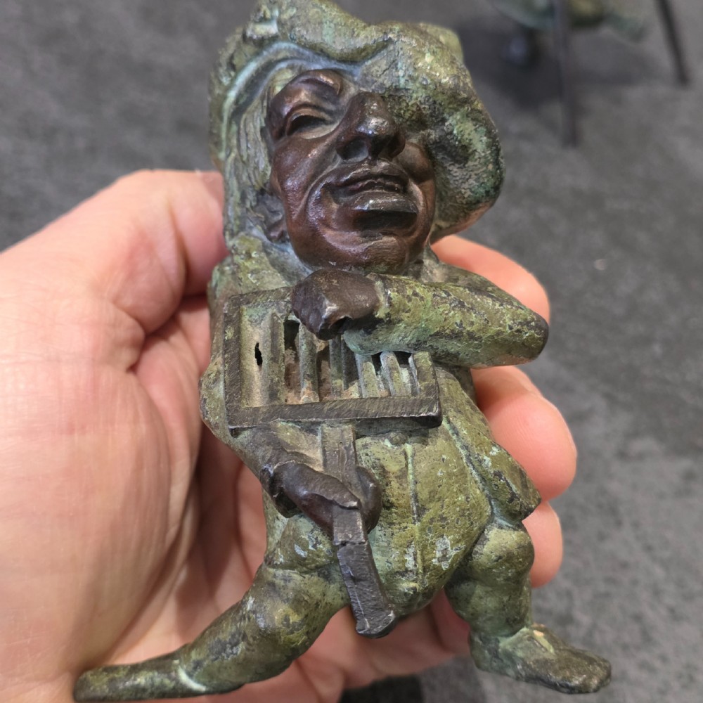 A pair of early twentieth-century French patinated bronze candle holders cast in the form of grotesque satirical caricature figures. View XIII