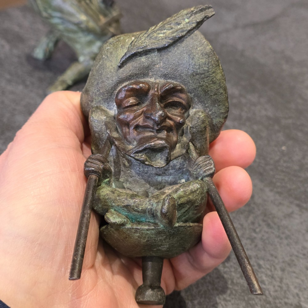 A pair of early twentieth-century French patinated bronze candle holders cast in the form of grotesque satirical caricature figures. View XV