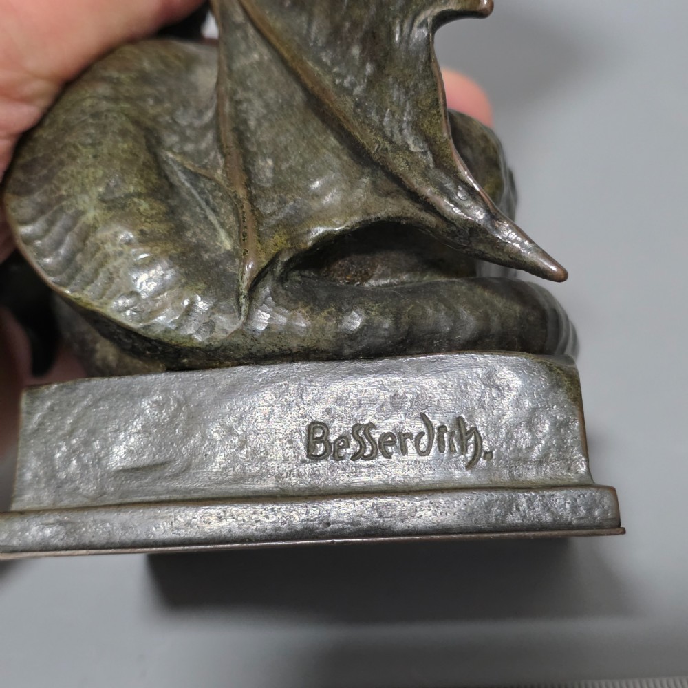 A patinated bronze sculpture depicting the mythical hero Siegfried standing victorious with a sword, winged helmet, and shield above a dragon base. View XIV