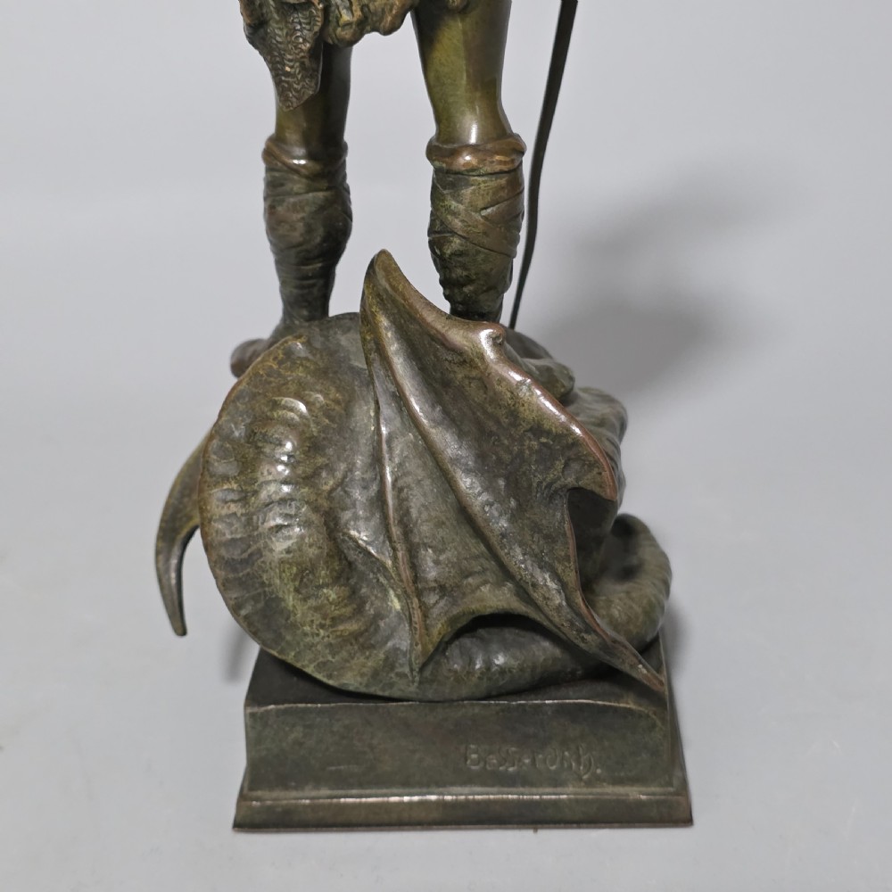 A patinated bronze sculpture depicting the mythical hero Siegfried standing victorious with a sword, winged helmet, and shield above a dragon base. View XIX