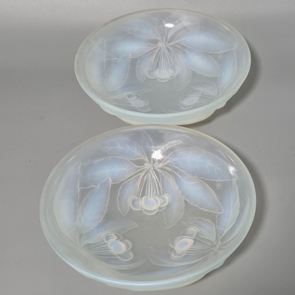 A pair of round 1930s French opalescent glass bowls featuring a moulded cherry and leaf design.