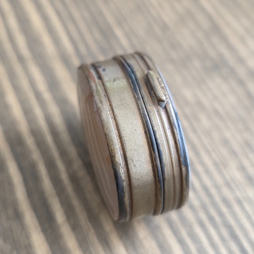 An oval Georgian gilt metal snuff box featuring a polished blue and grey banded agate stone inset on the lid. View XI