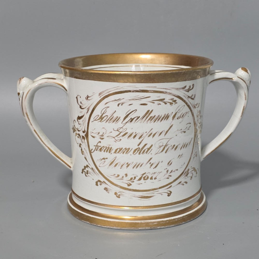 A nineteenth-century ceramic loving cup featuring two side handles, gilt trim, and a hand-painted landscape scene inside an oval cartouche. View III