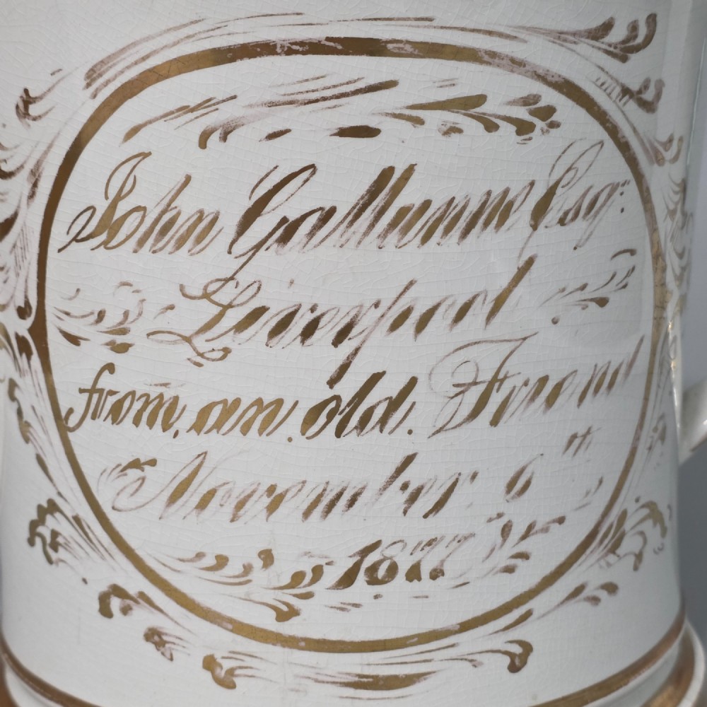 A nineteenth-century ceramic loving cup featuring two side handles, gilt trim, and a hand-painted landscape scene inside an oval cartouche. View IV