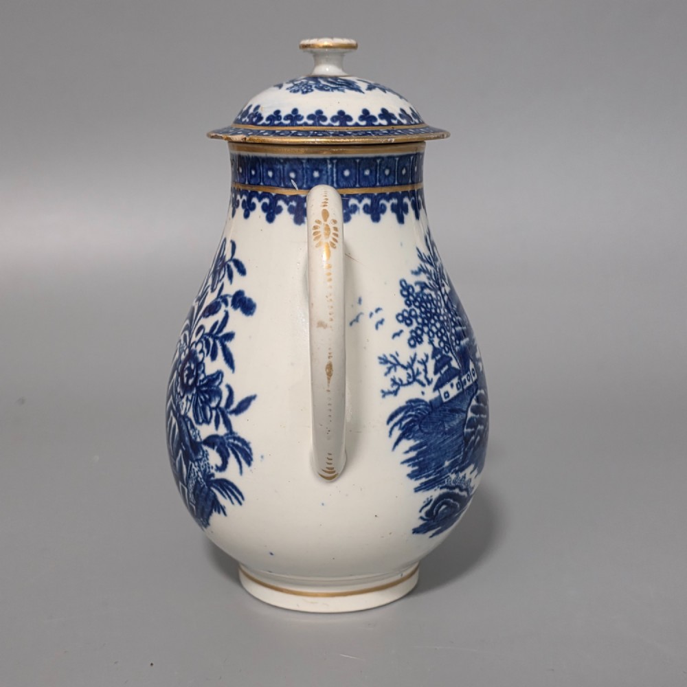 An 18th-century Worcester First Period soft-paste porcelain sparrow beak jug with cover, featuring a blue and white chinoiserie pattern and gilded rims. View II