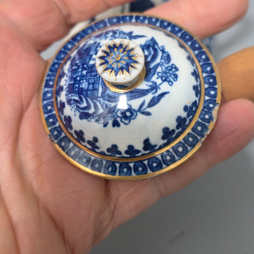 An 18th-century Worcester First Period soft-paste porcelain sparrow beak jug with cover, featuring a blue and white chinoiserie pattern and gilded rims. View IV
