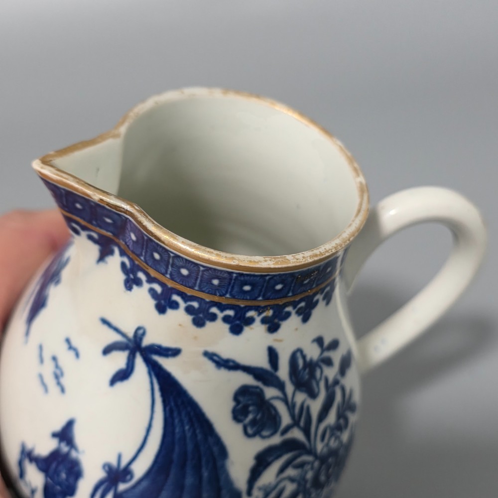 An 18th-century Worcester First Period soft-paste porcelain sparrow beak jug with cover, featuring a blue and white chinoiserie pattern and gilded rims. View V