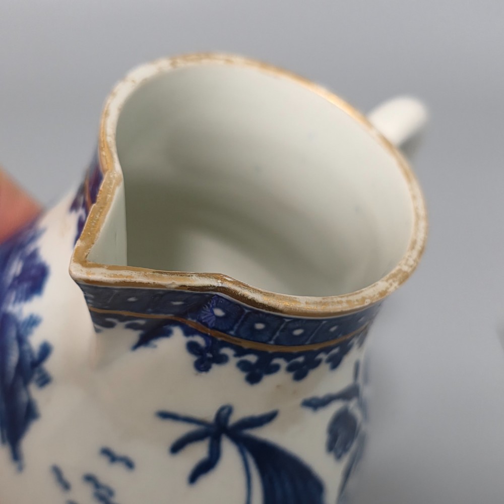 An 18th-century Worcester First Period soft-paste porcelain sparrow beak jug with cover, featuring a blue and white chinoiserie pattern and gilded rims. View VII