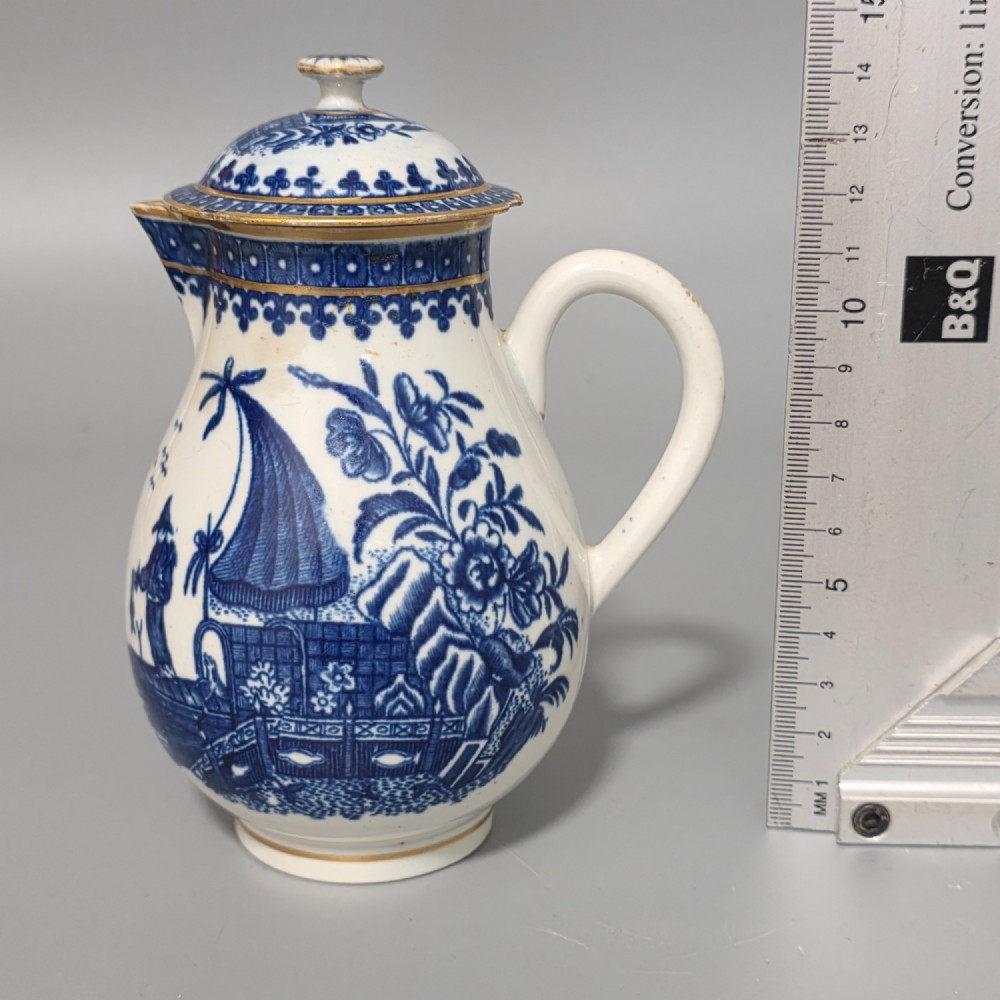 An 18th-century Worcester First Period soft-paste porcelain sparrow beak jug with cover, featuring a blue and white chinoiserie pattern and gilded rims. View XV