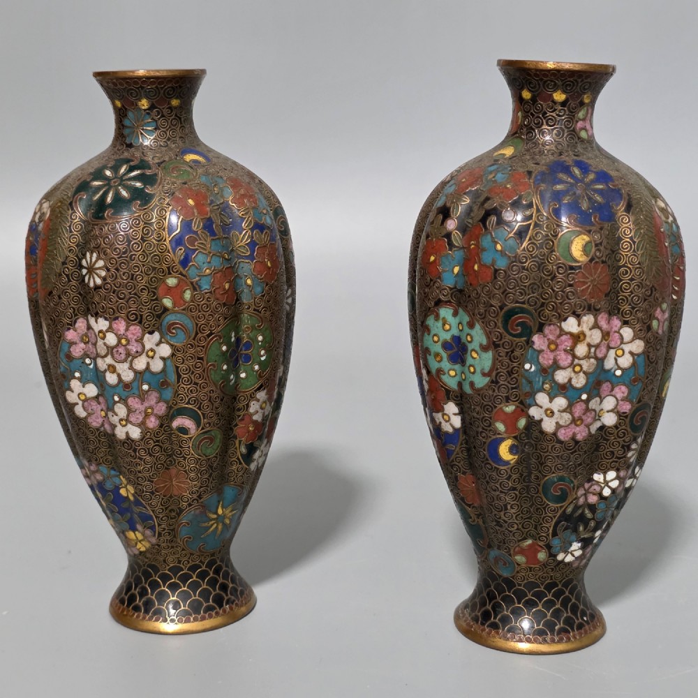 A pair of baluster-shaped Japanese cloisonne enamel vases decorated with intricate floral patterns, roundels, and scrollwork on a dark ground. View IV