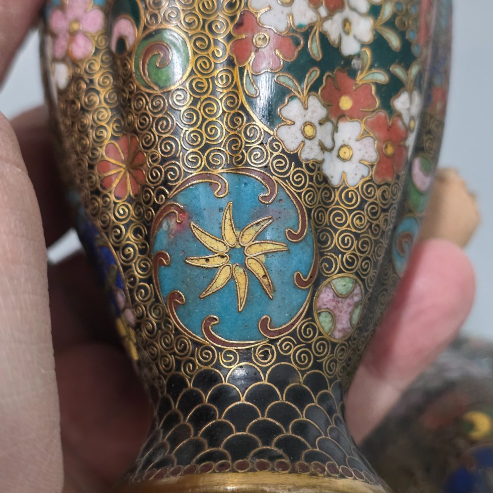 A pair of baluster-shaped Japanese cloisonne enamel vases decorated with intricate floral patterns, roundels, and scrollwork on a dark ground. View XI