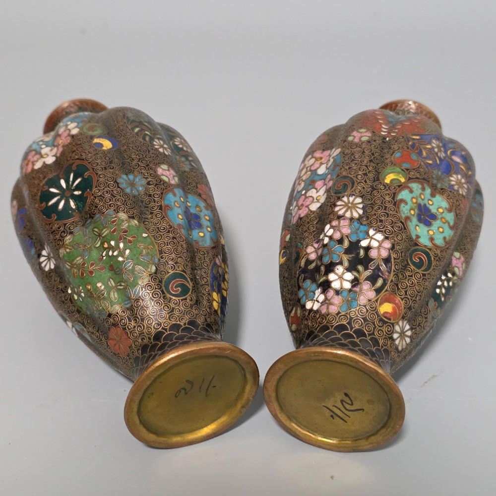 A pair of baluster-shaped Japanese cloisonne enamel vases decorated with intricate floral patterns, roundels, and scrollwork on a dark ground. View XIII