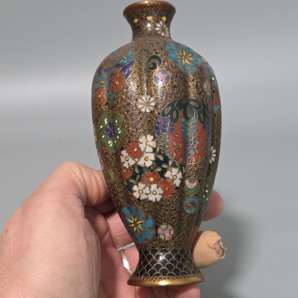A pair of baluster-shaped Japanese cloisonne enamel vases decorated with intricate floral patterns, roundels, and scrollwork on a dark ground. View XIV