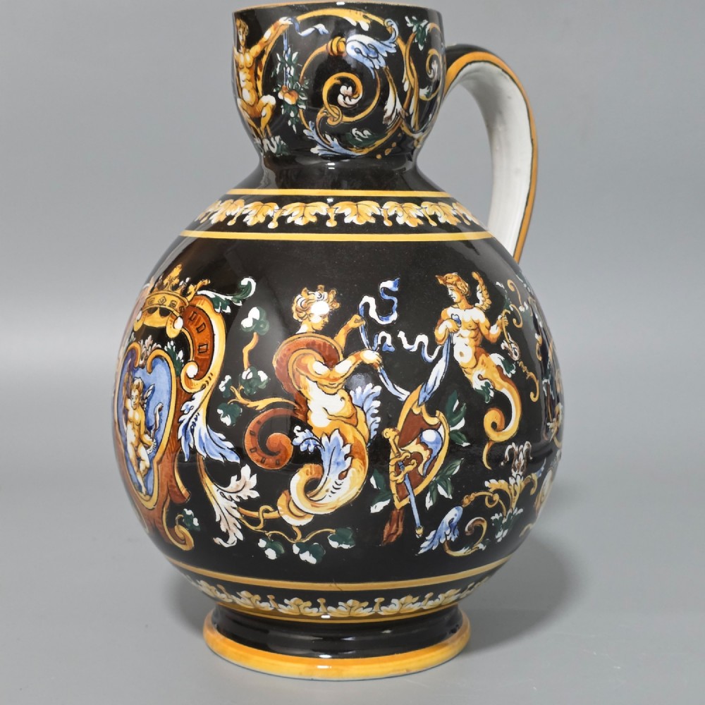 A nineteenth-century French Gien faience water pitcher featuring a black glazed body decorated with hand-painted ochre, white, and blue Renaissance revival mythological figures and scrolling foliage. View III