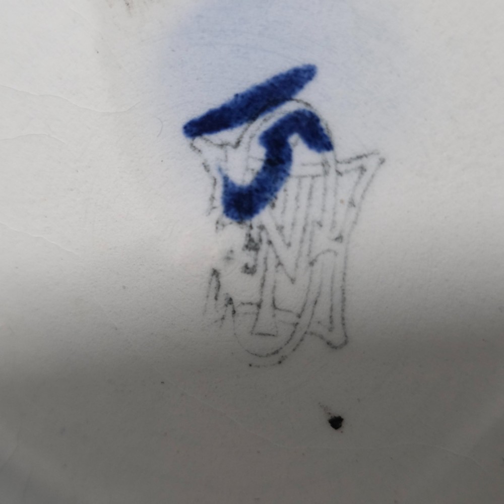 A nineteenth-century French Gien faience water pitcher featuring a black glazed body decorated with hand-painted ochre, white, and blue Renaissance revival mythological figures and scrolling foliage. View VI