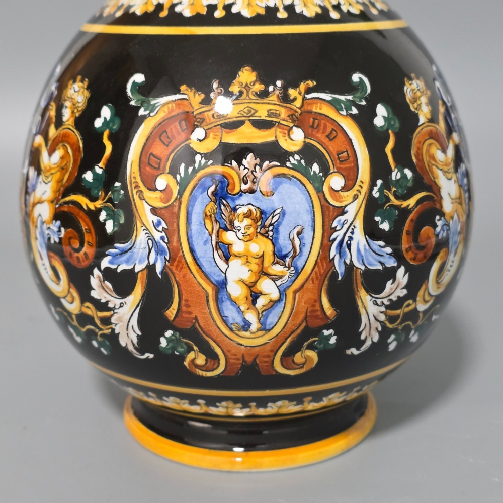 A nineteenth-century French Gien faience water pitcher featuring a black glazed body decorated with hand-painted ochre, white, and blue Renaissance revival mythological figures and scrolling foliage. View X