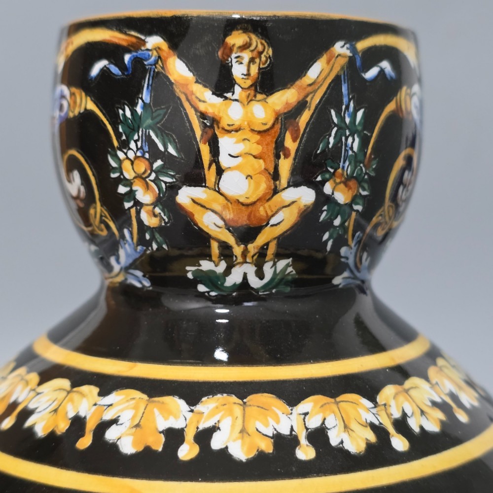 A nineteenth-century French Gien faience water pitcher featuring a black glazed body decorated with hand-painted ochre, white, and blue Renaissance revival mythological figures and scrolling foliage. View XI