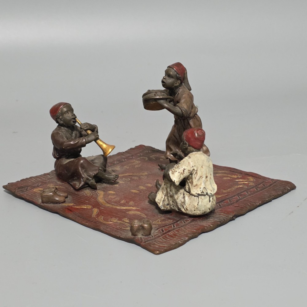 Franz Bergman (Austrian, 1861-1936) An Orientalist cold painted bronze group depicting three musicians on a rug Stamped 'Namgreb and B' and numbered '7813'