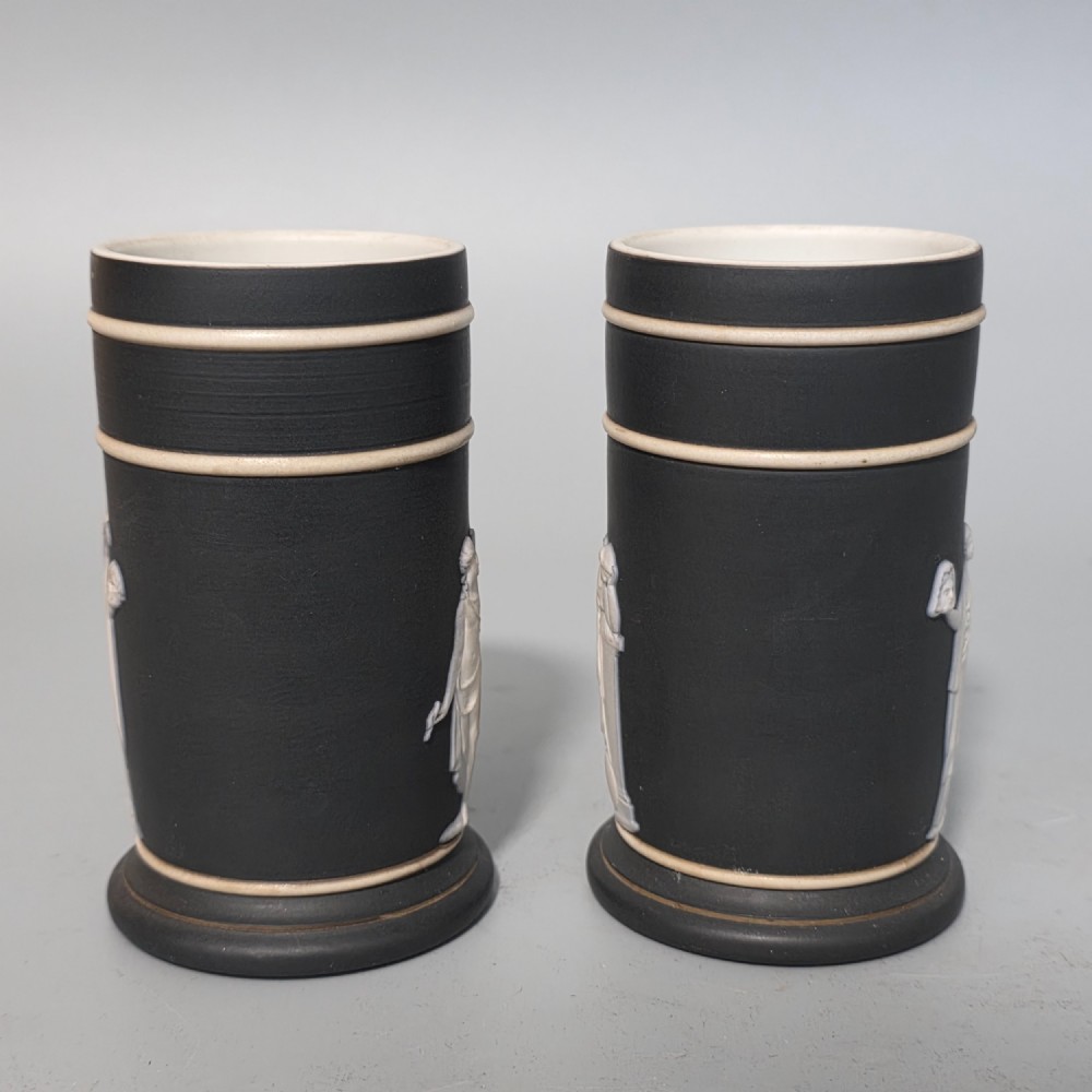 A pair of cylindrical black basalt spill holders featuring raised white neoclassical figures and white double-banded rims. View II